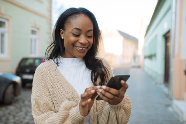African woman using smart phone outdoors